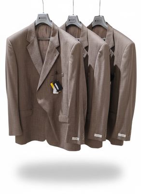 three suits hanging on a hanger on a white background