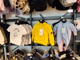 a lot of clothes on the shelves in the store