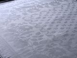 bedspread with a floral design on it sitting on top of a bed