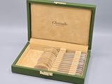 a green box with a set of silverware in it