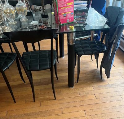 a glass dining table with black chairs in a room