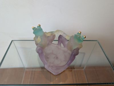 a glass table with a heart shaped object on top of it