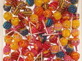colorful lollipops in a clear box on a white surface