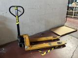 a pallet that is sitting on the ground next to a wall