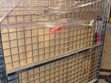 a large metal cage with a bunch of boxes in it