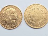 a close up of two gold coins on a white surface