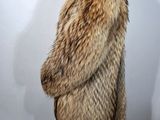 the woman is wearing a fur coat and black pants