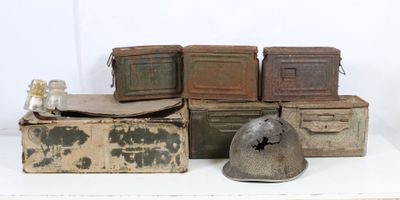 many old boxes and a helmet on a white table