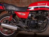 a red motorcycle that is parked in a garage