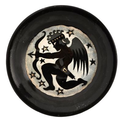 an image of a black and white plate with a cupid on it