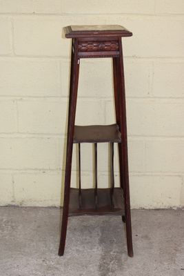 a small wooden stool with a shelf on it