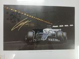 an autograph of a racing car is displayed in a frame