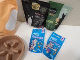 a bag of cat food, a bowl of catnip, and a bowl of catnips on a counter