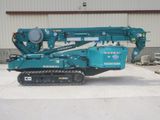 a blue crane that is parked in front of a building