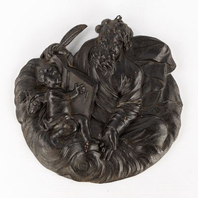 a statue of a man with a dog and a cat on a plate
