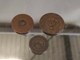 two coins sitting on top of a glass table