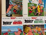 several cartoon books are stacked on top of each other on a table
