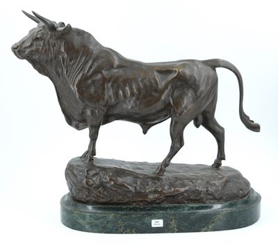 statue of a bull standing on a rock on a white background