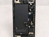 the back of a cell phone with a broken battery in it