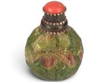 a small bottle with a red top on a white surface