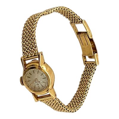 une photo d'une montre-bracelet pour femme avec un bracelet en or