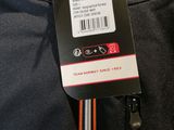 a close up of a jacket with a tag attached to it