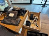 a desk with a computer, keyboard, mouse, and other electronics on it