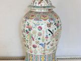 a vase with a lid sitting on a table