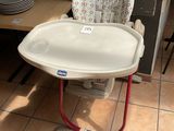 a baby high chair that is sitting in the kitchen