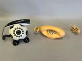 a white and black telephone and a yellow telephone