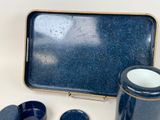 a blue tray with two cups and a tray with a tray on it
