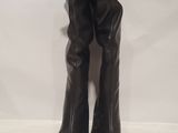 a pair of black boots sitting on top of a white table