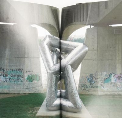 an open book with a picture of a sculpture inside of it