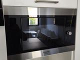 a microwave built into the wall in a kitchen