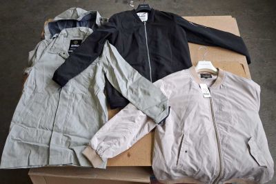 three jackets and a jacket are sitting on a cardboard box