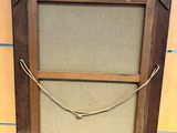 an old picture frame with a rope hanging from it ' s side