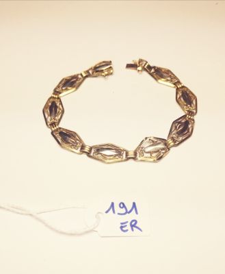 a picture of a bracelet and a tag on a table