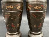 pair of asian vases on pedestal on grey background with black background
