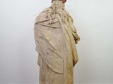 an image of a statue of a man in a robe on a wooden floor