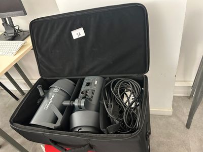 a black suitcase with two hair dryers inside of it