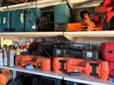many different types of tools on a shelf in a garage