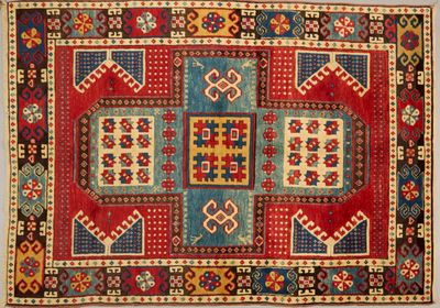 a red, blue, and yellow rug with geometric design