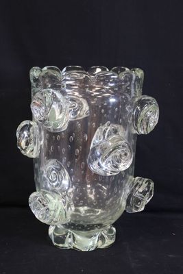 a glass vase that has a bunch of flowers on it
