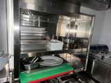 a kitchen with a stove, sink, and pots and pans in it