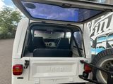 a white truck that has a bike in the back of it