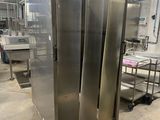 stainless steel double door refrigerators in a large industrial kitchen