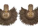 two pairs of silver and gold earrings with fringes on them