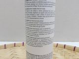 an image of a bottle of lotion sitting on a basket