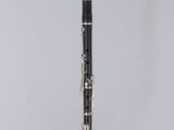 a black and silver clarinet sitting on top of a white table