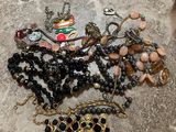 a lot of jewelry that is laying out on the floor